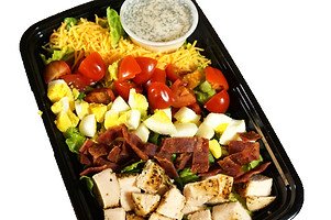 Nutritious meal prep container filled with a colorful balance of lean protein, whole grains, and leafy greens.